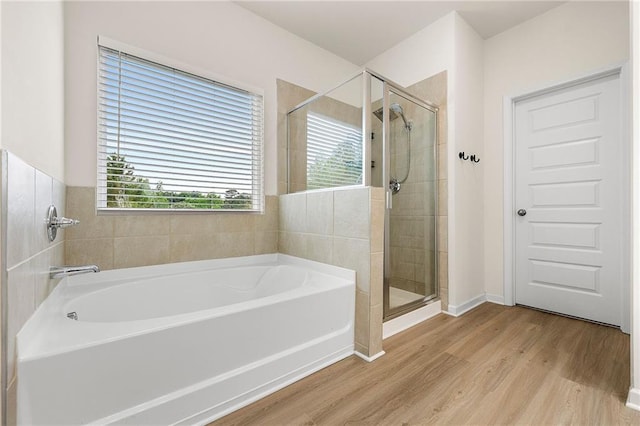 228 Whitneys Way, Dallas, GA 30157 - full bathroom featuring a bath, wood finished floors, and a shower stall
