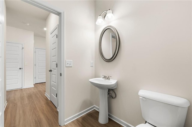 228 Whitneys Way, Dallas, GA 30157 - half bath with toilet, wood finished floors, baseboards, and a sink
