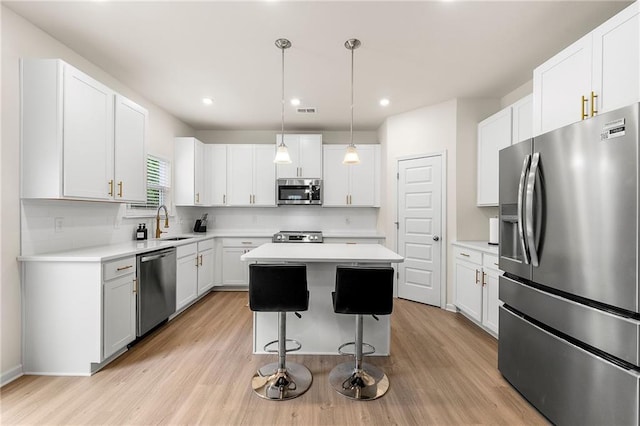 228 Whitneys Way, Dallas, GA 30157 - kitchen featuring appliances with stainless steel finishes, a sink, a center island, decorative backsplash, and light wood-style floors