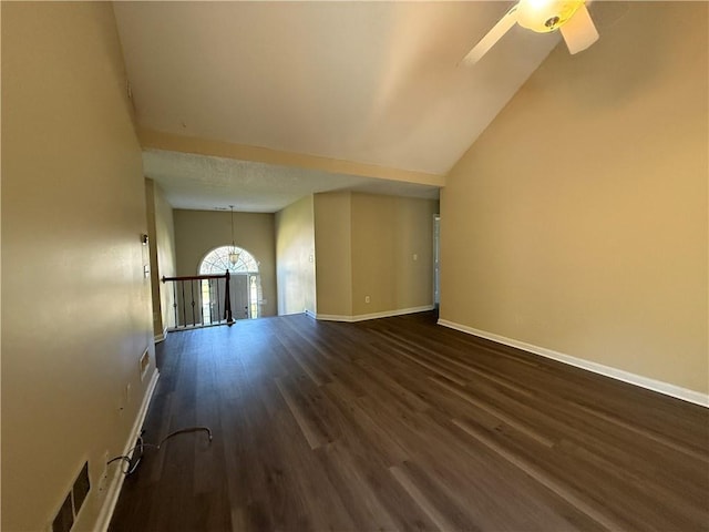 unfurnished living room with dark wood finished floors, baseboards, ceiling fan, and a chandelier