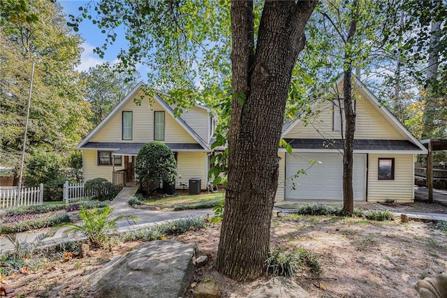 view of front of property with central AC unit and a garage