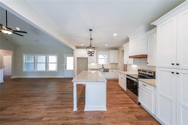 82 Lexie Ct, Rockmart, GA 30153 - kitchen with stainless steel range with electric cooktop, decorative backsplash, open floor plan, white cabinetry, and a sink