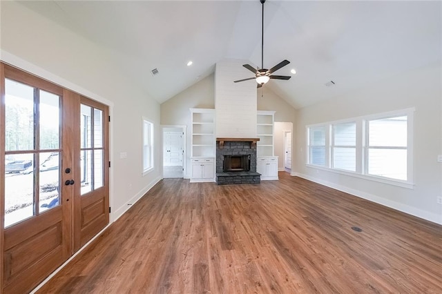 82 Lexie Ct, Rockmart, GA 30153 - unfurnished living room with a fireplace, baseboards, ceiling fan, wood finished floors, and healthy amount of natural light