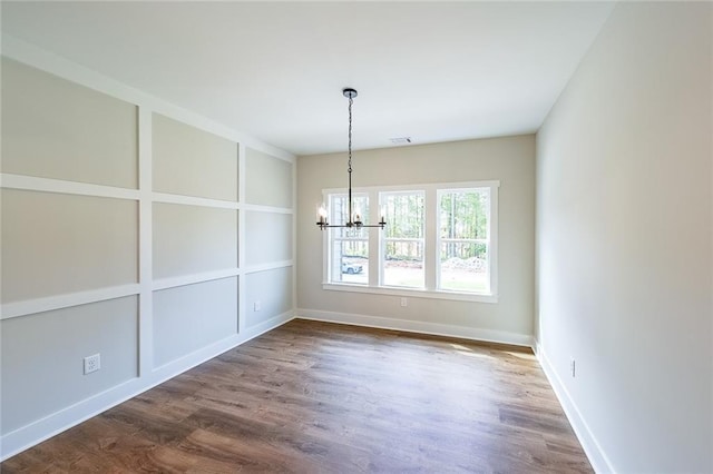 82 Lexie Ct, Rockmart, GA 30153 - spare room with a chandelier, dark wood finished floors, and baseboards