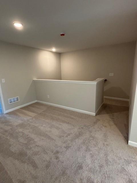 unfurnished room with light colored carpet