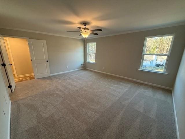 unfurnished bedroom with multiple windows, ceiling fan, carpet floors, and ornamental molding