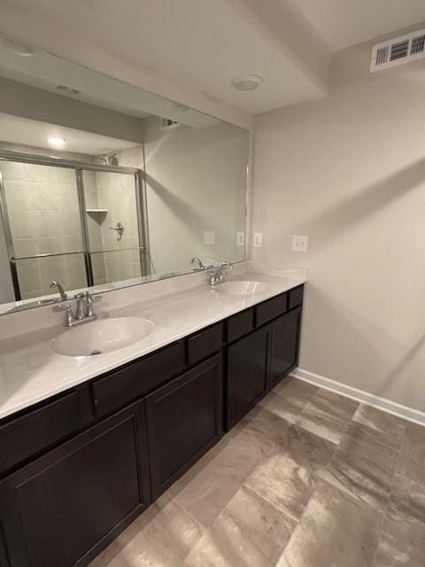 bathroom with vanity and an enclosed shower