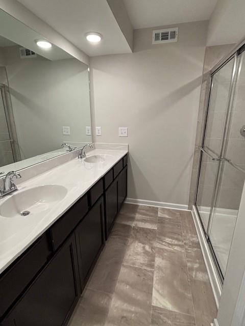 bathroom featuring vanity and an enclosed shower