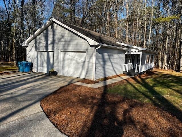 view of property exterior featuring a garage and a lawn