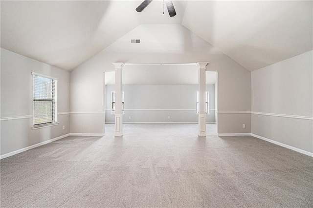 carpeted empty room featuring vaulted ceiling and ceiling fan