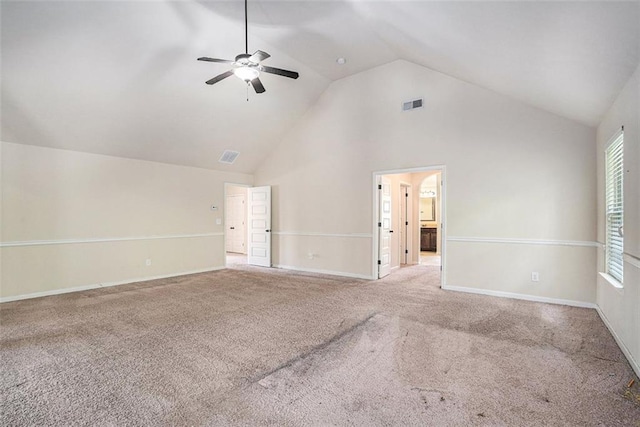 unfurnished living room with carpet flooring, high vaulted ceiling, and ceiling fan