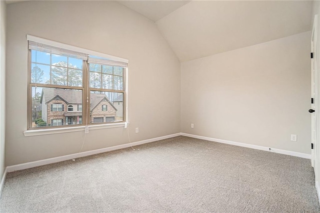 unfurnished room with carpet flooring and lofted ceiling