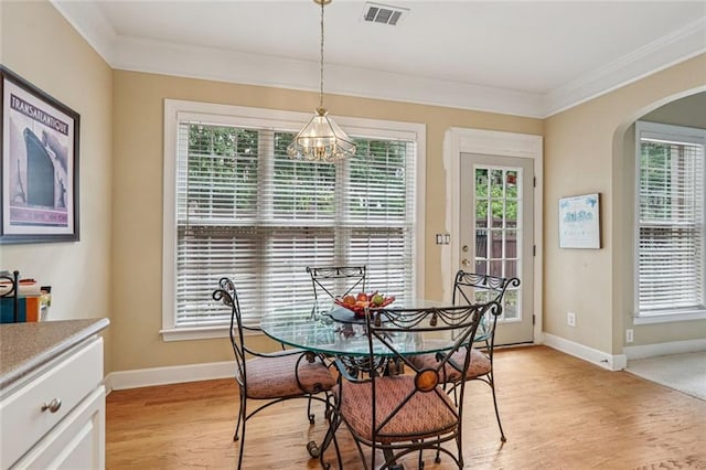 25 Hampreston Ct, Johns Creek, GA 30022 - dining room featuring arched walkways, a chandelier, crown molding, and light wood-style flooring