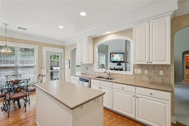 25 Hampreston Ct, Johns Creek, GA 30022 - kitchen with arched walkways, a kitchen island, healthy amount of natural light, white cabinetry, and recessed lighting