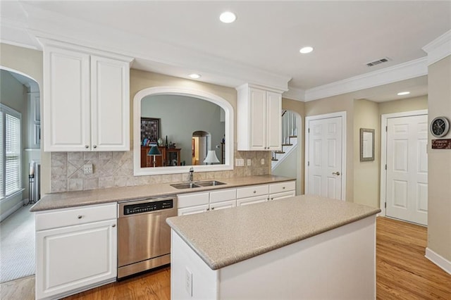 25 Hampreston Ct, Johns Creek, GA 30022 - kitchen featuring dishwasher, arched walkways, crown molding, white cabinetry, and a center island