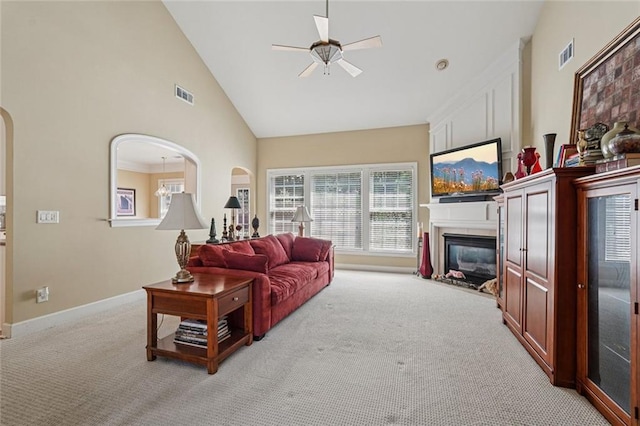 25 Hampreston Ct, Johns Creek, GA 30022 - living room with light carpet, a ceiling fan, high vaulted ceiling, a fireplace, and arched walkways