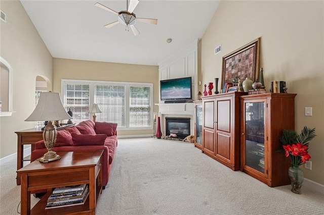 25 Hampreston Ct, Johns Creek, GA 30022 - carpeted living room featuring ceiling fan, a glass covered fireplace, and vaulted ceiling