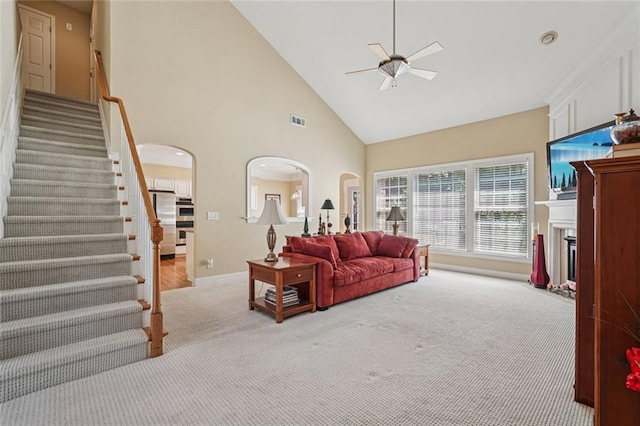 25 Hampreston Ct, Johns Creek, GA 30022 - carpeted living area with arched walkways, a ceiling fan, high vaulted ceiling, stairway, and a fireplace