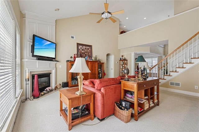 25 Hampreston Ct, Johns Creek, GA 30022 - living area featuring ceiling fan, light carpet, a glass covered fireplace, stairway, and high vaulted ceiling