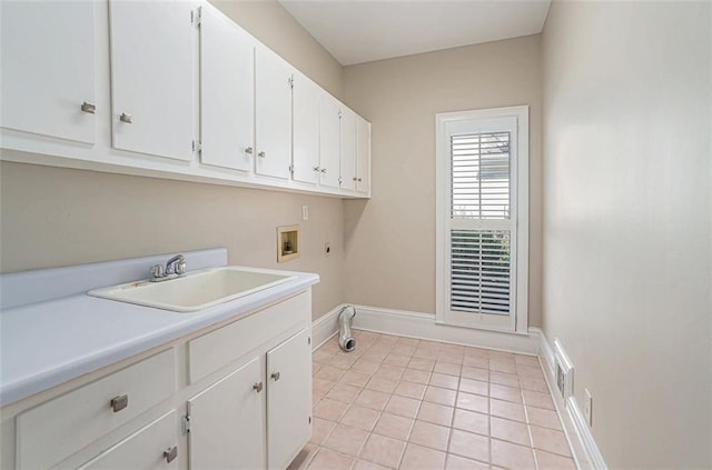 laundry room featuring light tile patterned floors, hookup for a washing machine, cabinets, and sink