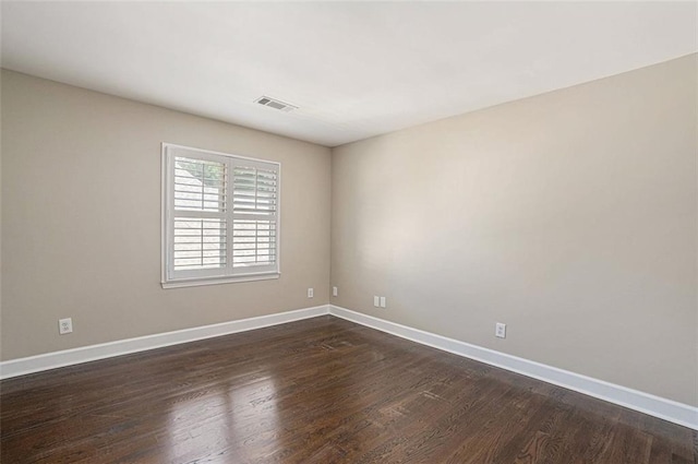 empty room featuring dark wood-type flooring