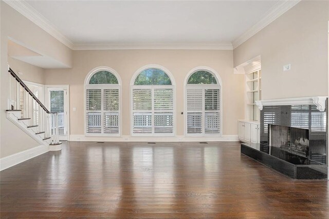 living room with a fireplace, dark hardwood / wood-style flooring, and ornamental molding