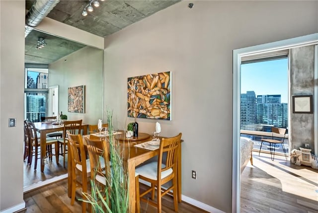 dining area featuring baseboards and wood finished floors