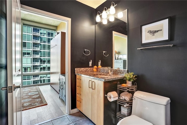 bathroom featuring vanity and toilet