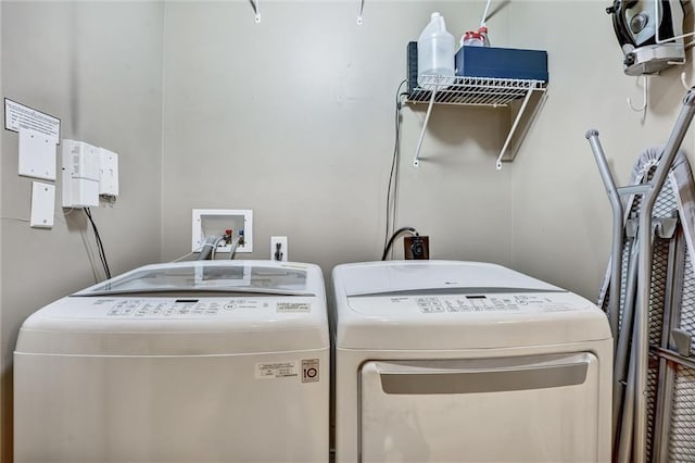 washroom featuring laundry area and separate washer and dryer