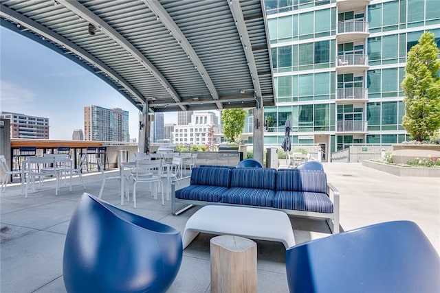 view of patio with an outdoor hangout area and a city view