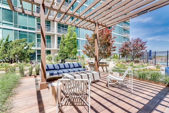 wooden deck featuring an outdoor living space and a pergola