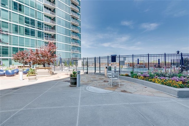 surrounding community with fence and a patio