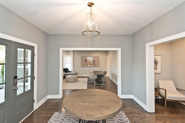 foyer featuring a chandelier, dark hardwood / wood-style floors, and french doors