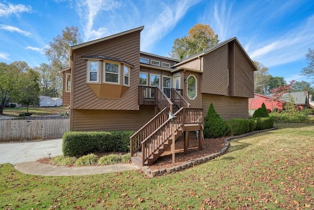 rear view of house featuring a lawn