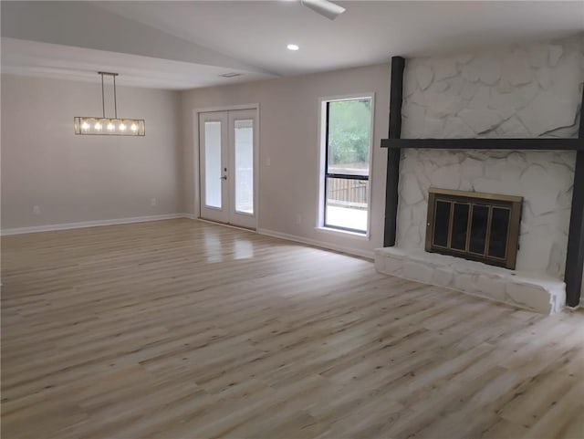 2645 Trotters Walk Trl, Snellville, GA 30078 - unfurnished living room featuring wood finished floors, baseboards, french doors, a stone fireplace, and vaulted ceiling