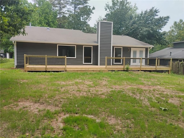2645 Trotters Walk Trl, Snellville, GA 30078 - back of property with a wooden deck, a chimney, and a yard