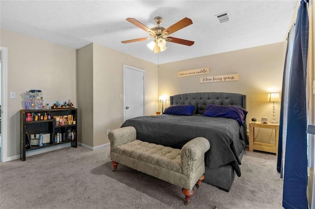 bedroom featuring a ceiling fan, a textured ceiling, baseboards, carpet flooring, and visible vents