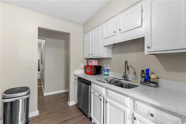 kitchen with stainless steel dishwasher, a sink, white cabinets, baseboards, and dark wood-style flooring