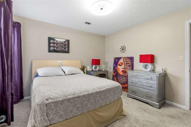 bedroom with baseboards, visible vents, and carpet