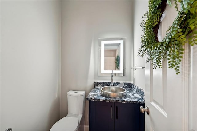 bathroom with toilet and vanity