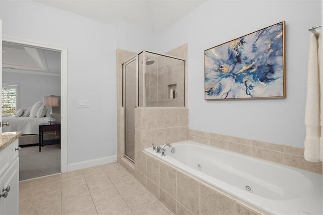 bathroom featuring tile patterned flooring, shower with separate bathtub, and vanity