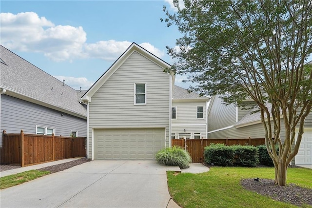 view of front of house featuring a garage and a front lawn