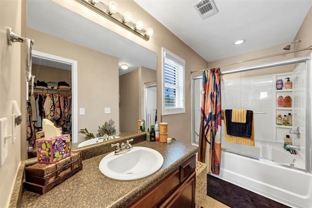 bathroom with visible vents, a walk in closet, recessed lighting, shower / bath combination with curtain, and vanity