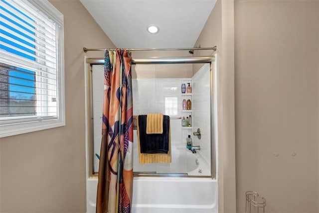 bathroom with a wealth of natural light and enclosed tub / shower combo