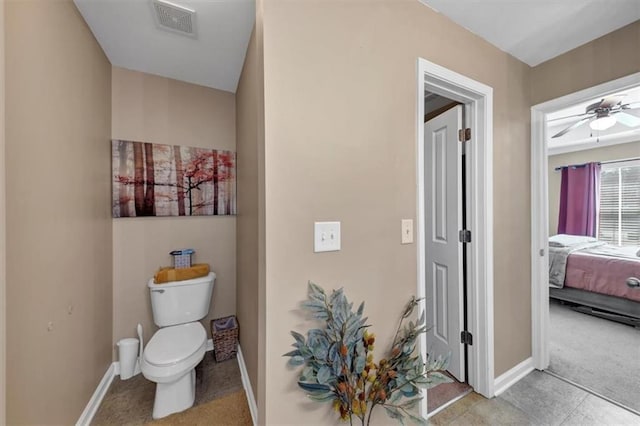 bathroom with ensuite bath, visible vents, toilet, and baseboards