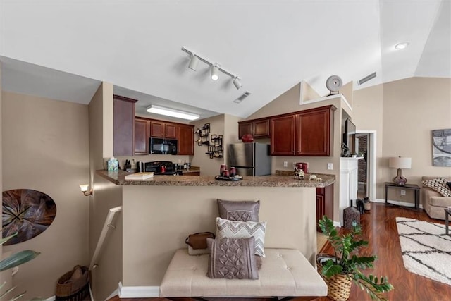 kitchen featuring lofted ceiling, freestanding refrigerator, stove, dark wood-type flooring, and black microwave