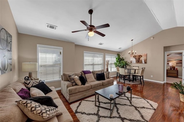 living room with vaulted ceiling, visible vents, ceiling fan with notable chandelier, and wood finished floors