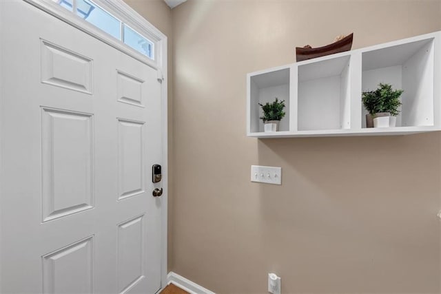 foyer entrance featuring baseboards