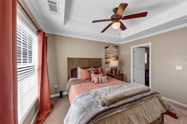 bedroom with visible vents, baseboards, carpet, and a tray ceiling