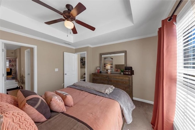 bedroom featuring a raised ceiling, carpet flooring, baseboards, and ceiling fan